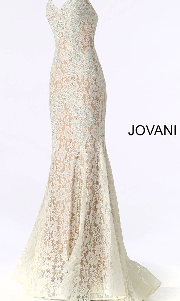 The Jovani Long Prom Dress 37334 is a form-fitting, floor-length gown in cream lace with a floral pattern, featuring a subtle train. This elegant formal dress is pictured from the side.